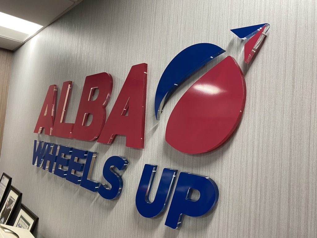 Attractive acrylic sign of ALBA Wheels Up for Office space